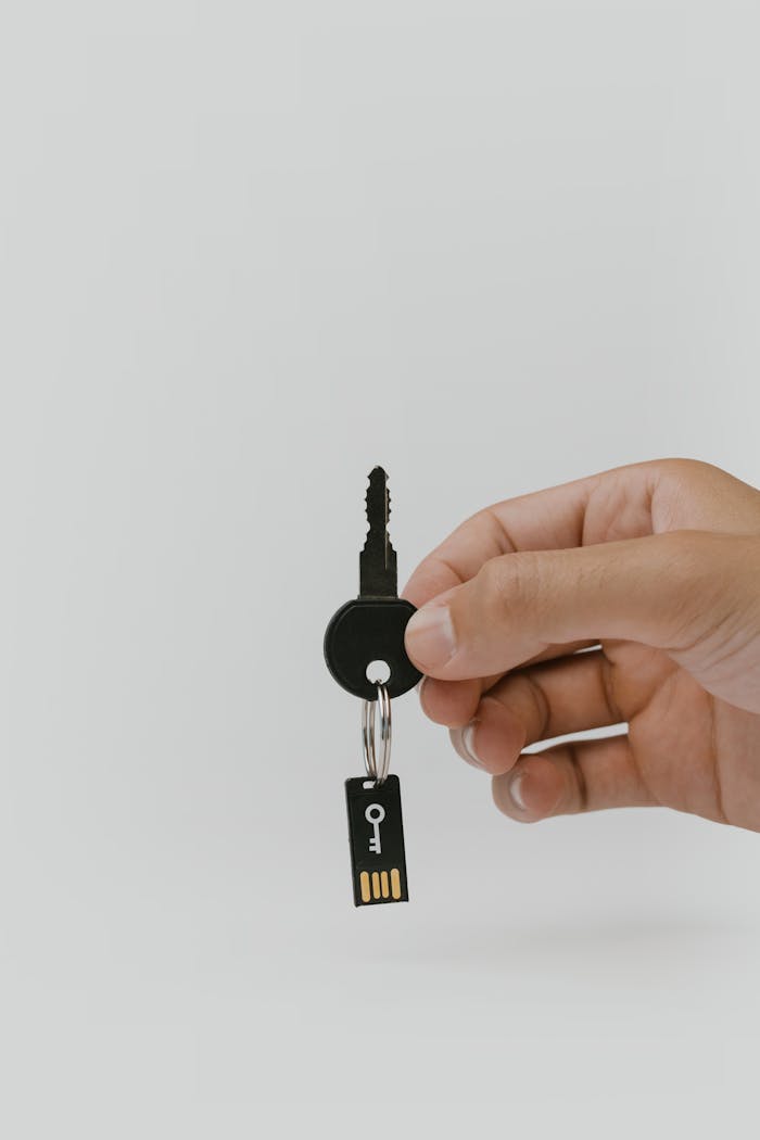Home Close-up of a hand holding a key and USB with copyspace.